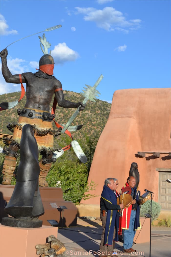 Singers of Native traditional songs, drummed and sang at the foot of Craig Dan Goseyun's "Mountain Spirit Dancer".
