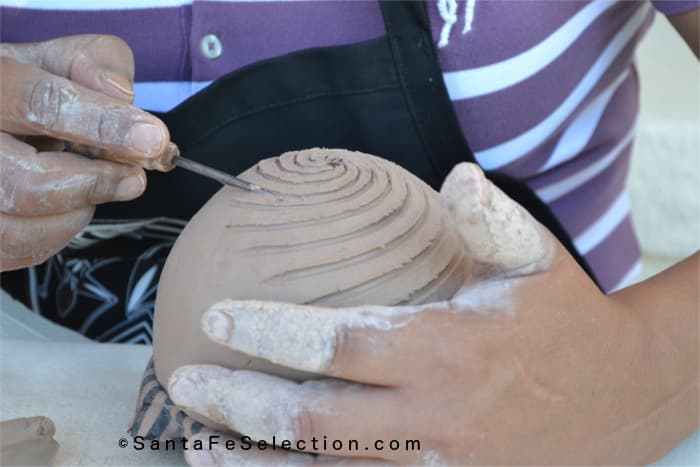 Dominique Toya - Jemez Pueblo. Carving in the decoration to the seed pot.